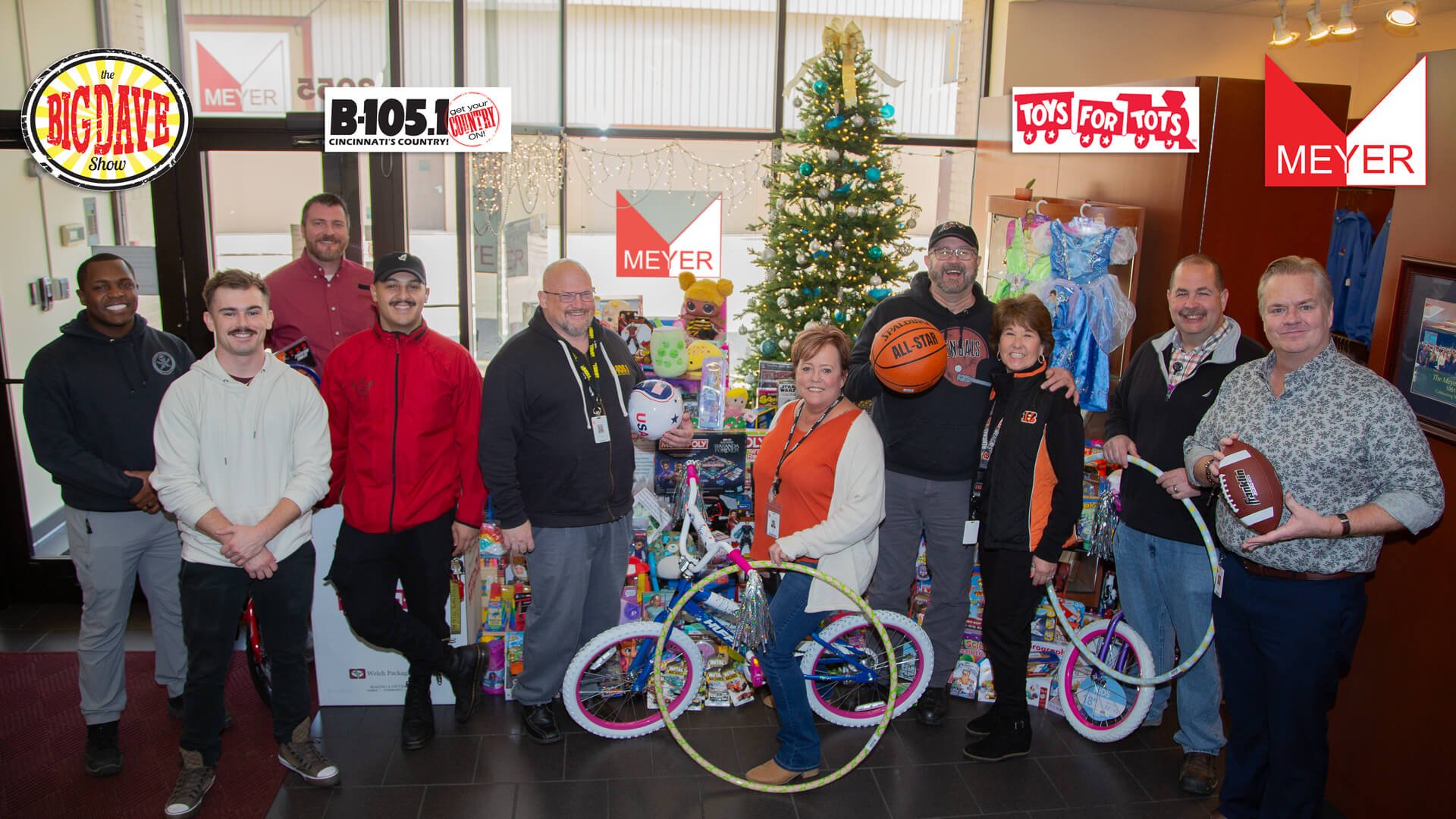 group of Meyer employees in front of a stack of toys